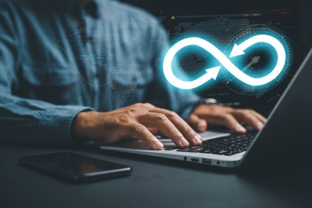 DevOps engineer in agile environment. infinity icon on computer